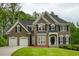 Stunning two-story home featuring a meticulously manicured lawn and a convenient two-car garage at 5595 Timson Ln, Johns Creek, GA 30022