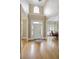 Inviting foyer featuring gleaming hardwood floors, high ceilings, and an abundance of natural light at 5595 Timson Ln, Johns Creek, GA 30022