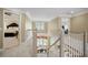 Carpeted second story hallway with staircase visible, window, and doorways to bedrooms at 5595 Timson Ln, Johns Creek, GA 30022
