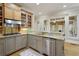 Modern kitchen featuring stainless steel appliances, granite counters, and an adjacent sunroom at 5595 Timson Ln, Johns Creek, GA 30022