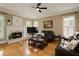 Warm and inviting living room with hardwood floors, a fireplace and comfortable seating at 5595 Timson Ln, Johns Creek, GA 30022