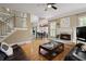 Inviting living room features a fireplace, hardwood floors, and stairs to the upper level at 5595 Timson Ln, Johns Creek, GA 30022