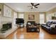 Relaxing living room with hardwood floors, large windows and cozy furnishings at 5595 Timson Ln, Johns Creek, GA 30022