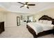 Spacious main bedroom suite with sitting area, fireplace, tray ceiling, and carpeted floor at 5595 Timson Ln, Johns Creek, GA 30022