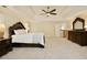 Spacious main bedroom suite with tray ceiling, carpeted floor, and full furniture set at 5595 Timson Ln, Johns Creek, GA 30022