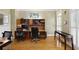 Spacious home office with hardwood floors and built-in shelving, perfect for working from home at 5595 Timson Ln, Johns Creek, GA 30022