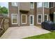 Back patio perfect for outdoor entertaining, complete with a grill and access to the fenced backyard at 5595 Timson Ln, Johns Creek, GA 30022