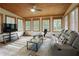 Relaxing sun room featuring tile floors, wood ceiling, and comfortable seating area at 5595 Timson Ln, Johns Creek, GA 30022