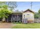 Charming backyard with a screened porch, lush lawn, and a storage shed adding convenience at 72 Griggs Sw St, Marietta, GA 30064