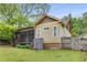 Landscaped backyard featuring a screened porch, storage shed, and a well-maintained lawn at 72 Griggs Sw St, Marietta, GA 30064