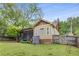 Landscaped backyard featuring a screened porch, storage shed, and a well-maintained lawn at 72 Griggs Sw St, Marietta, GA 30064