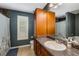 Bathroom features a sink, toilet, shower-tub combo, granite countertops, and wood cabinets at 72 Griggs Sw St, Marietta, GA 30064