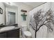 Bathroom featuring modern fixtures, a granite countertop, and a shower with a tree-themed curtain at 72 Griggs Sw St, Marietta, GA 30064