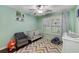 Cozy Bedroom with a soft color palette, patterned rug, a crib and a comfortable chair at 72 Griggs Sw St, Marietta, GA 30064
