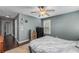 This bedroom features a ceiling fan, window with shutters, and dark hardwood floors at 72 Griggs Sw St, Marietta, GA 30064