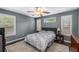 Bedroom featuring hardwood floors, a ceiling fan, neutral walls, and two windows at 72 Griggs Sw St, Marietta, GA 30064