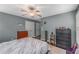 Comfortable bedroom with dark hardwood floors, gray walls, ceiling fan, and abundant closet space at 72 Griggs Sw St, Marietta, GA 30064