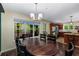 Dining room featuring a wooden table with view of the deck, kitchen, and outdoor greenery through large windows at 72 Griggs Sw St, Marietta, GA 30064