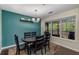Inviting dining room with a modern chandelier, colorful rug and large windows bringing the outside in at 72 Griggs Sw St, Marietta, GA 30064