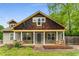 Charming home featuring a covered front porch with wooden porch swings, stone supports and a landscaped yard at 72 Griggs Sw St, Marietta, GA 30064