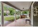 Inviting front porch with wooden porch swing, white columns, stone supports and a decorative front door with wreath at 72 Griggs Sw St, Marietta, GA 30064