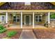 Inviting front porch with wooden porch swings, white columns, and a decorative front door with floral wreath at 72 Griggs Sw St, Marietta, GA 30064