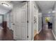 Open hallway featuring hardwood floors, a series of doors, and neutral paint at 72 Griggs Sw St, Marietta, GA 30064