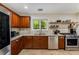 Kitchen with stainless steel appliances, granite countertops, and a tile backsplash, and wooden cabinetry at 72 Griggs Sw St, Marietta, GA 30064