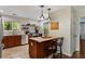 Kitchen with stainless steel appliances, granite countertops, tile backsplash, and island with pendant lights at 72 Griggs Sw St, Marietta, GA 30064
