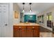 Kitchen island with wooden cabinetry, stainless appliances, looking out to living and dining rooms at 72 Griggs Sw St, Marietta, GA 30064