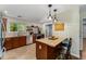 Kitchen with stainless steel appliances, granite countertops, tile backsplash, and island with pendant lights at 72 Griggs Sw St, Marietta, GA 30064