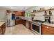Kitchen with stainless steel appliances, granite countertops, and a tile backsplash, and wooden cabinetry at 72 Griggs Sw St, Marietta, GA 30064