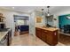 Kitchen featuring stainless appliances, wooden cabinetry, and a breakfast bar, looking out to living and dining rooms at 72 Griggs Sw St, Marietta, GA 30064