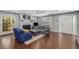 Comfortable living room featuring a fireplace, hardwood floors, light gray walls, and a view into the kitchen at 72 Griggs Sw St, Marietta, GA 30064
