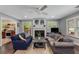 Comfortable living room featuring a fireplace, hardwood floors, light gray walls, and a view into the kitchen at 72 Griggs Sw St, Marietta, GA 30064