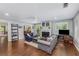 Comfortable living room featuring a fireplace, hardwood floors, light gray walls, and a view into the kitchen at 72 Griggs Sw St, Marietta, GA 30064