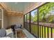 The screened porch has string lights, comfortable seating, and backyard views at 72 Griggs Sw St, Marietta, GA 30064