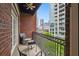 Private balcony with seating area and views of the city skyline and greenery at 850 Piedmont Ne Ave # 1409, Atlanta, GA 30308