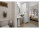 Charming bathroom with a pedestal sink, storage, and a view into a bedroom space at 850 Piedmont Ne Ave # 1409, Atlanta, GA 30308