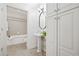 Bright bathroom featuring a pedestal sink, ample storage, and a separate tub with shower at 850 Piedmont Ne Ave # 1409, Atlanta, GA 30308