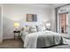 Bright bedroom featuring a large bed, bedside tables with lamps, and access to a private balcony at 850 Piedmont Ne Ave # 1409, Atlanta, GA 30308