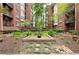 Lush courtyard with manicured garden beds, trees, and a central planter at 850 Piedmont Ne Ave # 1409, Atlanta, GA 30308