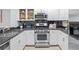Well-equipped kitchen featuring stainless steel appliances, granite countertops, and sleek white cabinetry at 850 Piedmont Ne Ave # 1409, Atlanta, GA 30308
