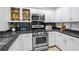 Modern kitchen featuring stainless steel appliances, granite countertops, and sleek white cabinetry at 850 Piedmont Ne Ave # 1409, Atlanta, GA 30308
