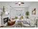 Cozy living room with a fireplace, a ceiling fan, and bay windows offering natural light at 850 Piedmont Ne Ave # 1409, Atlanta, GA 30308