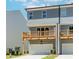 Rear exterior view of townhome with a wooden deck and a visible garage door at 1230 Ainsworth Aly # 34, Sugar Hill, GA 30518