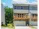 View of townhome with garage and deck, showcasing the building's rear exterior at 1230 Ainsworth Aly # 34, Sugar Hill, GA 30518