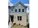 Beautiful townhome featuring a charming brick facade and stylish blue siding at 1230 Ainsworth Aly # 34, Sugar Hill, GA 30518