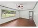 Bright living room featuring hardwood floors, a ceiling fan, and a large window for ample natural light at 2823 Connally Sw Dr, Atlanta, GA 30311