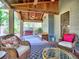 Relaxing covered back porch featuring wicker chairs, a swing, ceiling fan, and wooded views at 2859 Seagrave Way, Marietta, GA 30066
